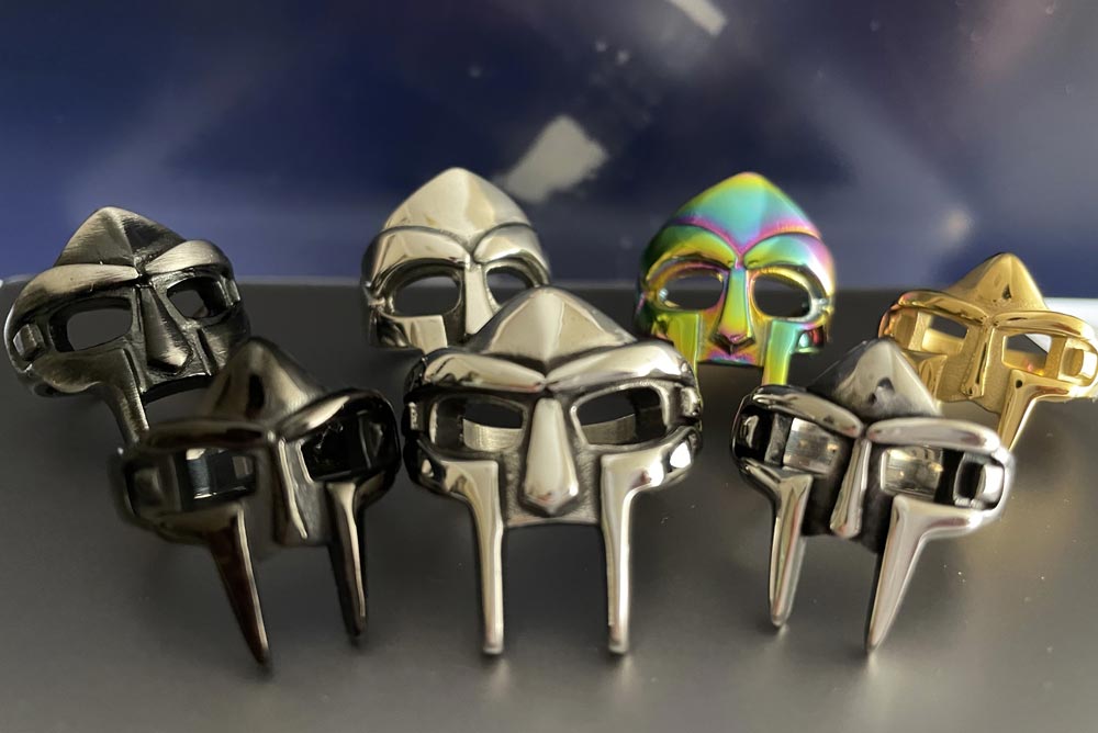 Seven MF doom rings in different colors and styles